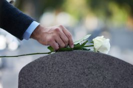 placing of flower on gravestone