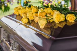 Wooden coffin with yellow flowers
